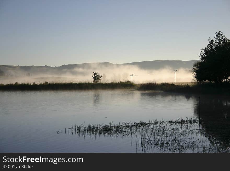 Mist rising on early morning water. Mist rising on early morning water