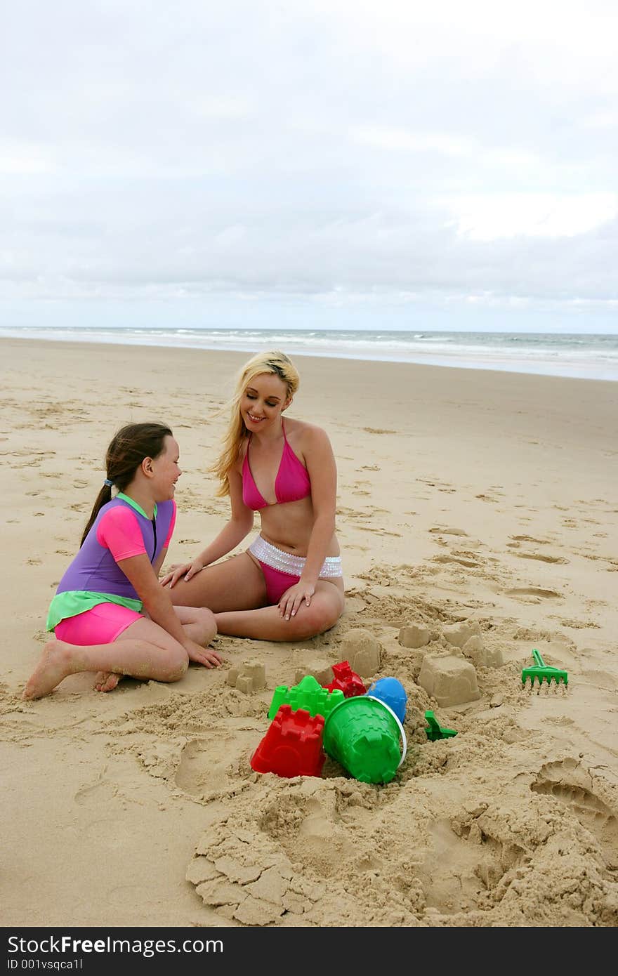 Teen and child having fun on the beach. Teen and child having fun on the beach.