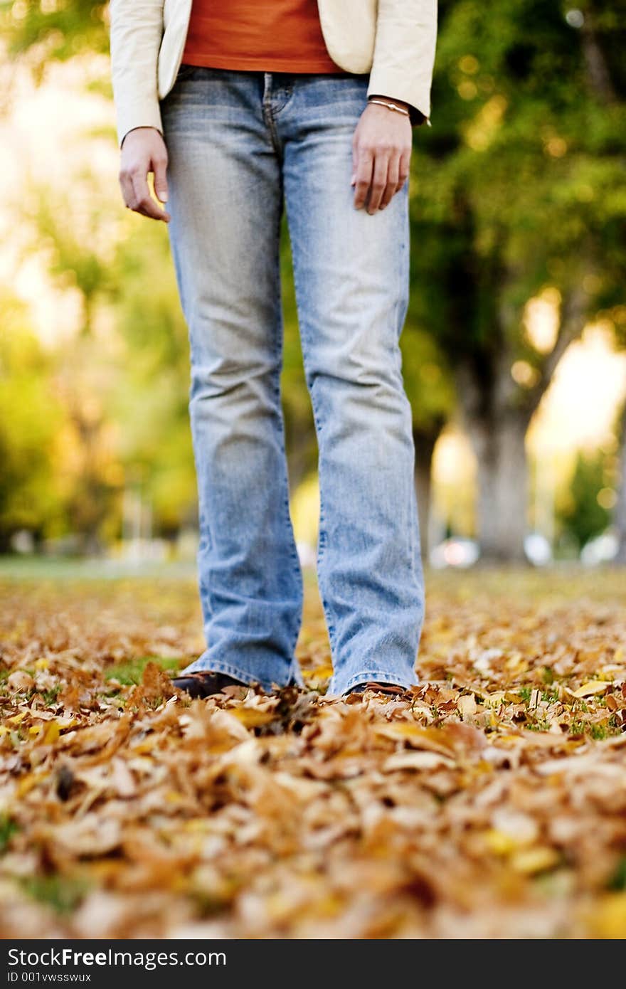 Woman standing outside in the fall leaves. Woman standing outside in the fall leaves