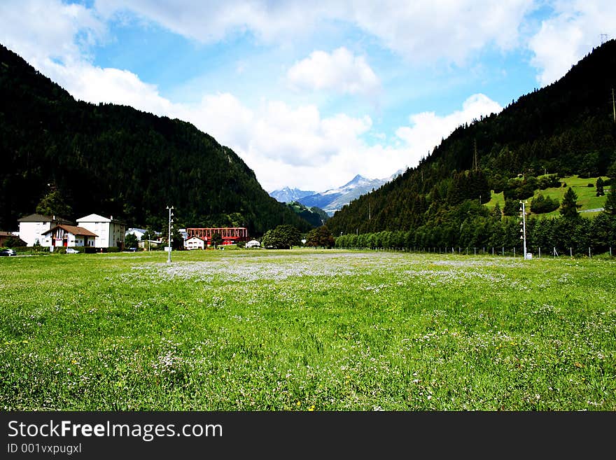 A medow sorounded by mountain with snow mountain behind. Taken near titils, Switzerland. A medow sorounded by mountain with snow mountain behind. Taken near titils, Switzerland.