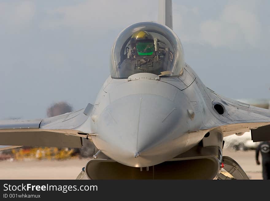 Close-up of an air force pilot in the cockpit of an American warplane. Head-on view. Close-up of an air force pilot in the cockpit of an American warplane. Head-on view.