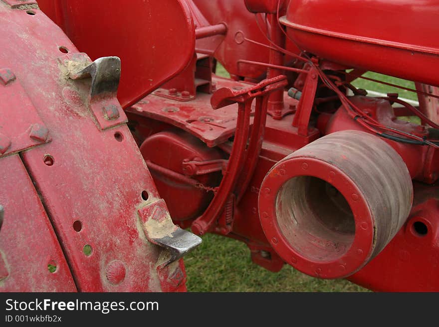 The workings of a red farm tractor. The workings of a red farm tractor
