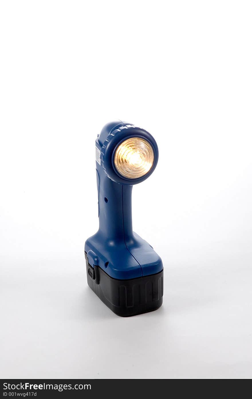 A battery operated flashlight with light on. A battery operated flashlight with light on