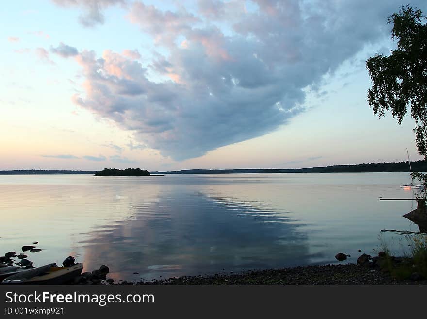 Cloud shaped like a pyramid mirrored in the water. Cloud shaped like a pyramid mirrored in the water.