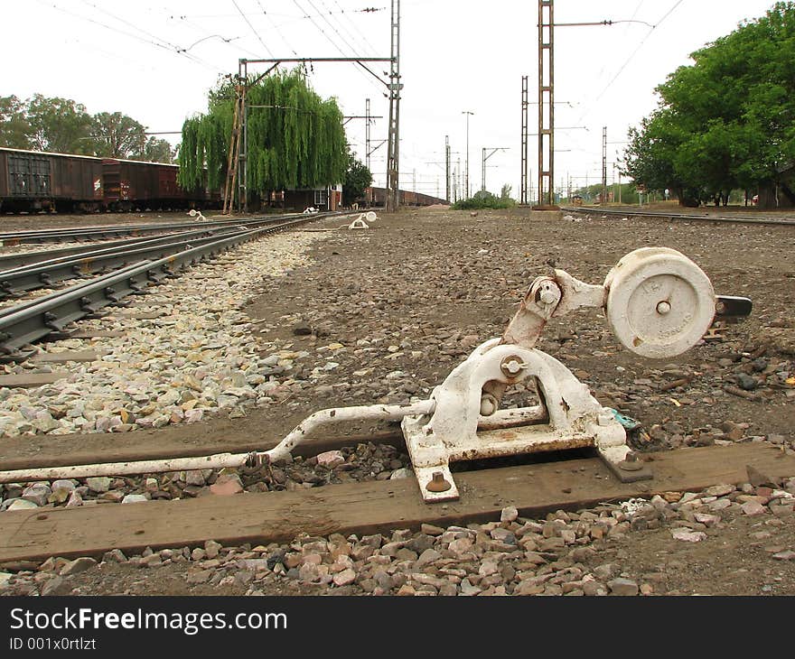 A Photo of a rail switcher with the train station as a background