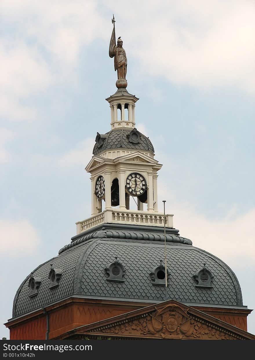 A Beautiful clock tower of a very old building. A Beautiful clock tower of a very old building