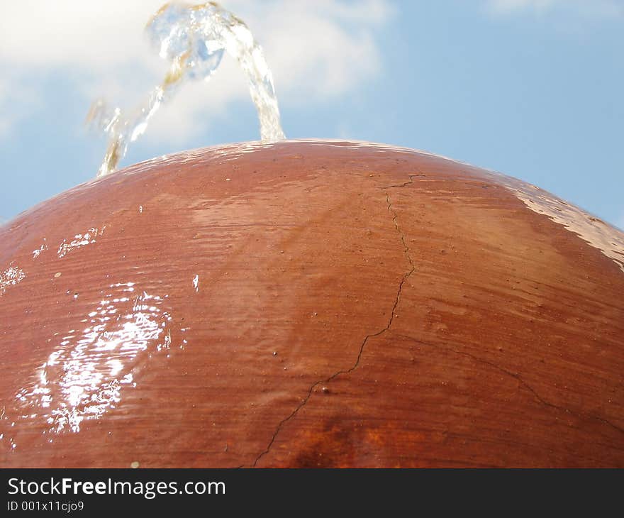 A Water fountain coming out of a concrete ball