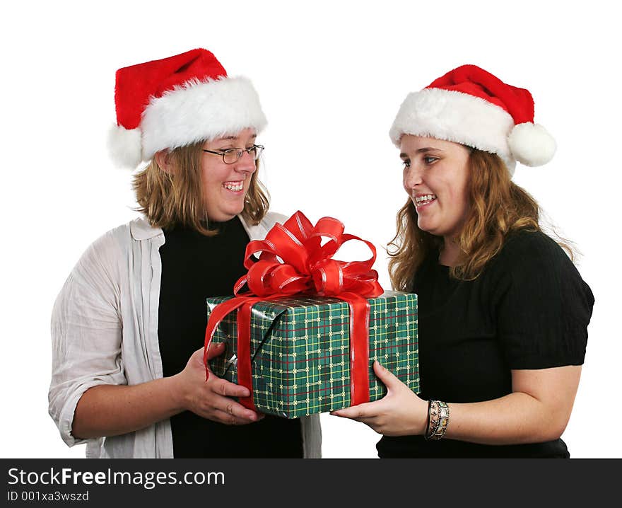 Two girls exchanging Christmas gifts. Two girls exchanging Christmas gifts.