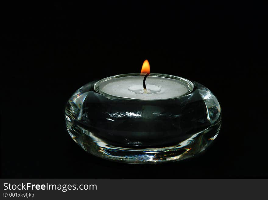 Candle in transparent glass vase