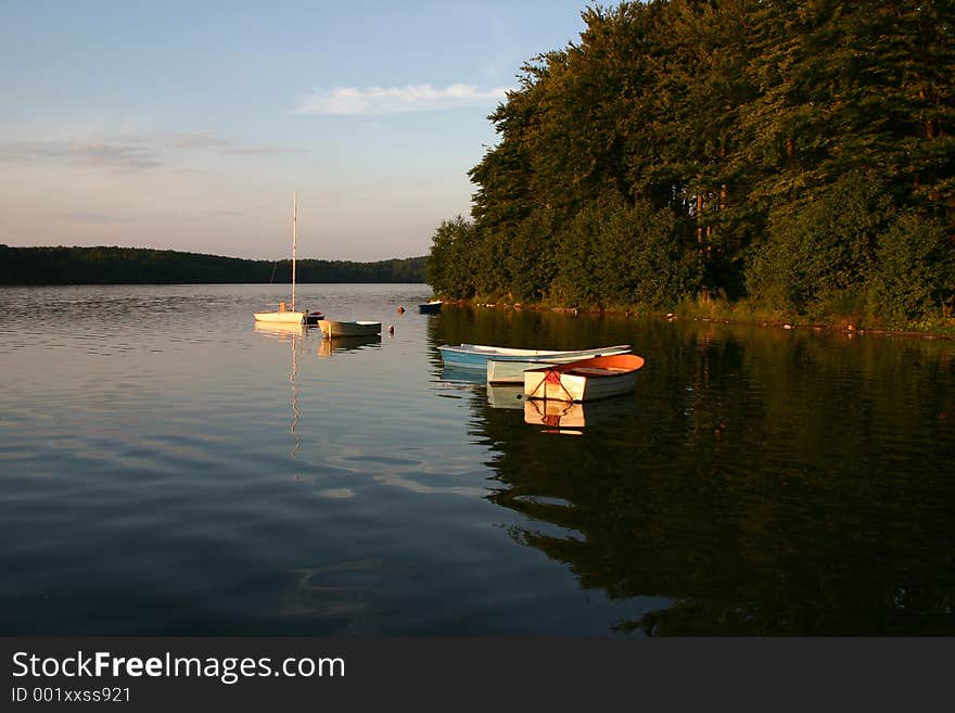 Bay boats on a lake at sunset. Bay boats on a lake at sunset.