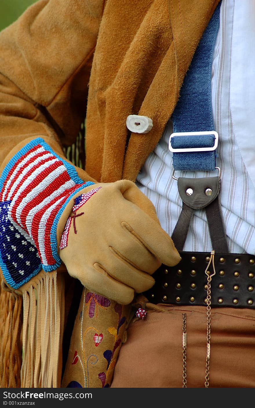 Man in buckskin coat wearing beaded gloves and suspenders. Man in buckskin coat wearing beaded gloves and suspenders