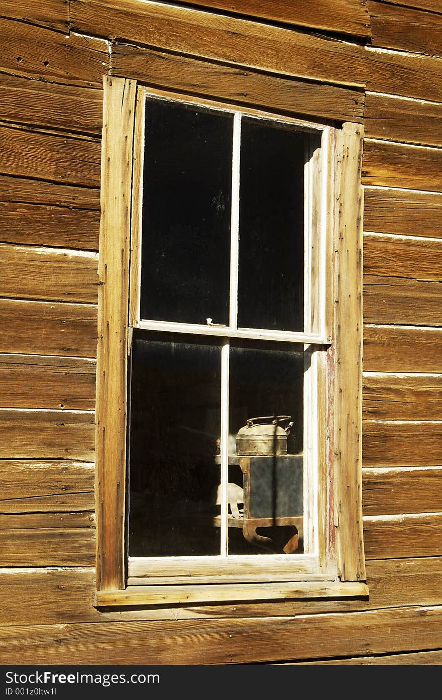 View of a kitchen through a ghost town window.