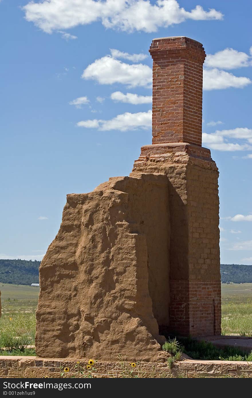 A brick chimney, pieces of the foundation, and the remains of an adobe wall are all that remain of one of the officers' quarters at old Fort Union National Monument in New Mexico. A brick chimney, pieces of the foundation, and the remains of an adobe wall are all that remain of one of the officers' quarters at old Fort Union National Monument in New Mexico.