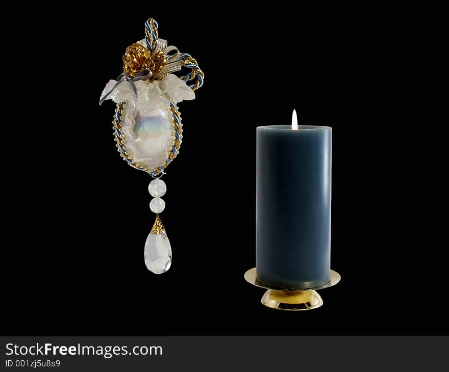 Hanging Christmas ornament and lighted candle. Hanging Christmas ornament and lighted candle