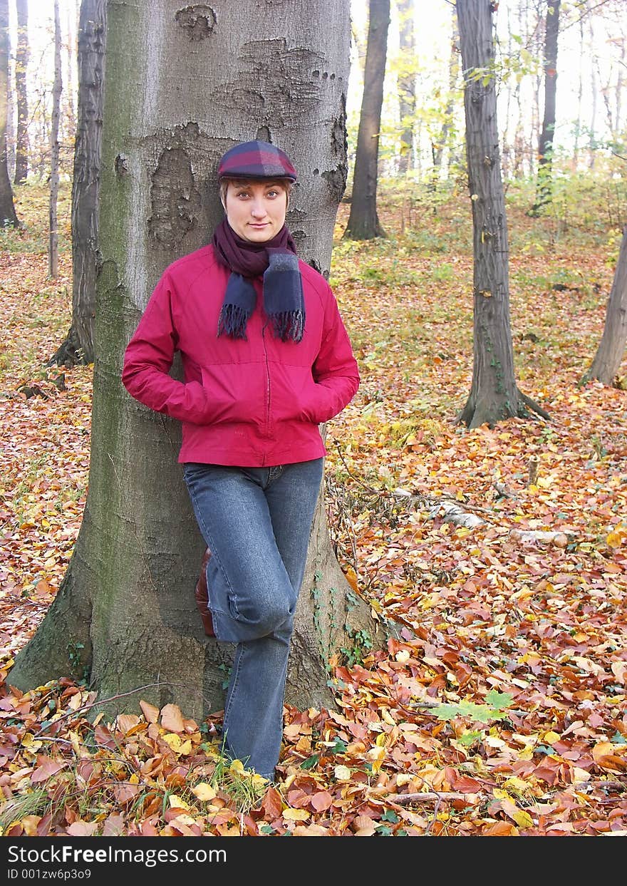 Model in vizored cap and muffler resting against a tree. Model in vizored cap and muffler resting against a tree