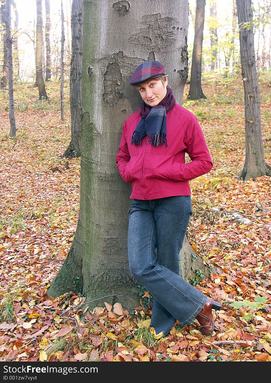 Model in vizored cap and muffler resting against a tree. Model in vizored cap and muffler resting against a tree