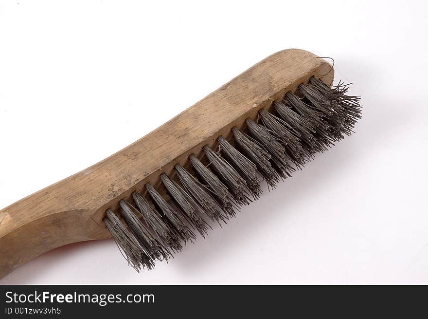 A wire brush photographed from the side