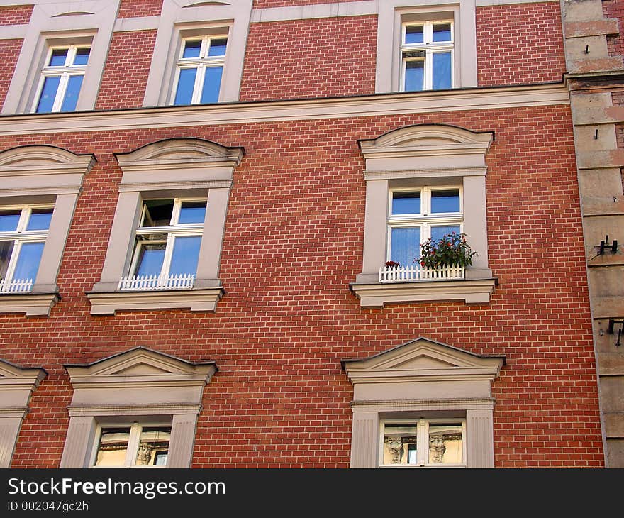 Brick wall with windows and flowers. Brick wall with windows and flowers