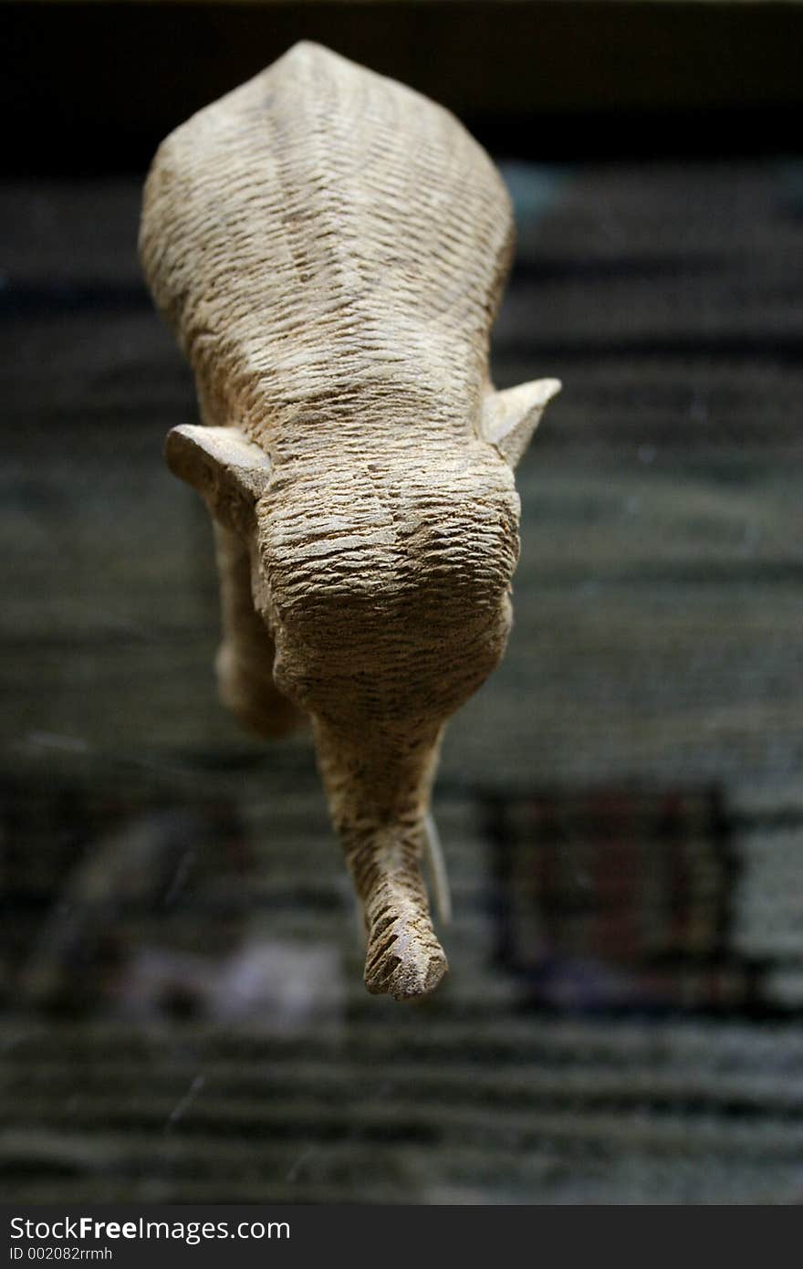 Elephant carved out of wood standing on table. Elephant carved out of wood standing on table