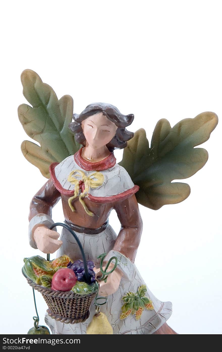 close up of a figure used for decoration at Thanksgiviing. Wooden Angel with leaves for wings. close up of a figure used for decoration at Thanksgiviing. Wooden Angel with leaves for wings