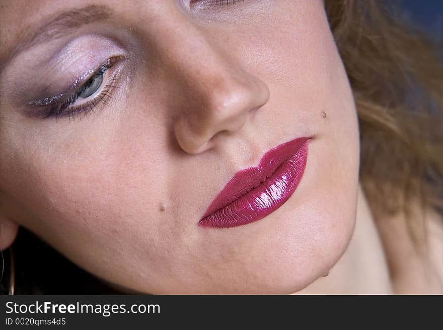 Extreme close-up of lips with cherry lipstick