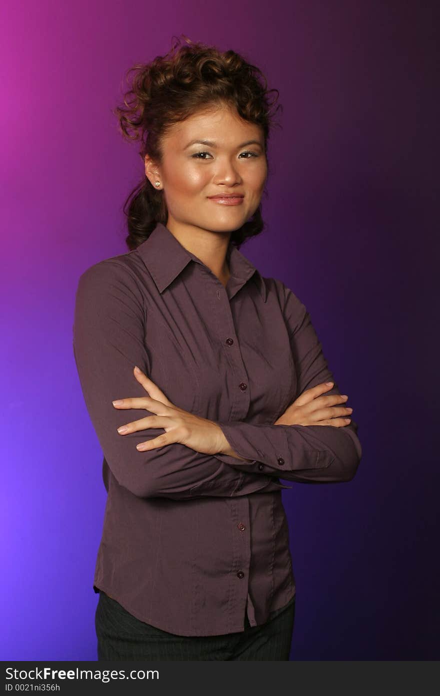 Pose of a Japanese girl on blue and purple backdrop