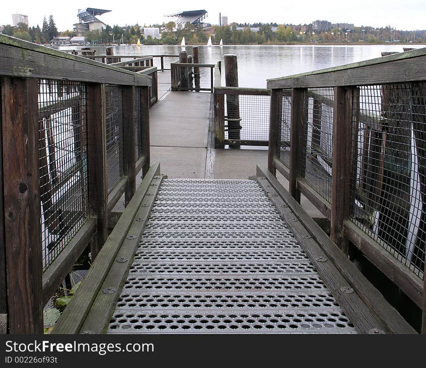 A series of platforms and walkways thread the small islands that are part of the University of Washington's Arboretum. In the background you can see the UW's Husky Stadium. A series of platforms and walkways thread the small islands that are part of the University of Washington's Arboretum. In the background you can see the UW's Husky Stadium.