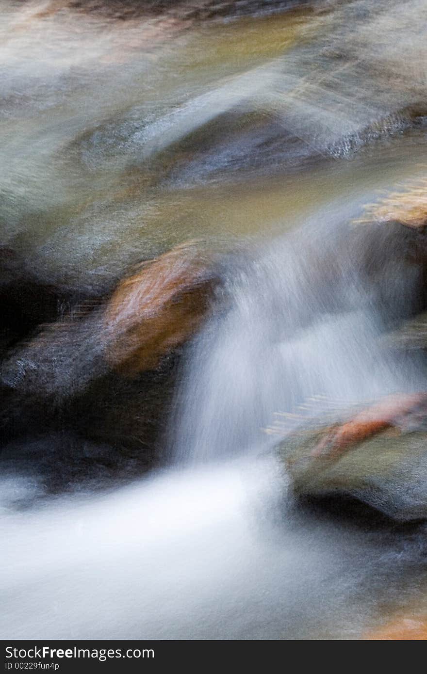 An abstract image of water flowing over rocks. An abstract image of water flowing over rocks.