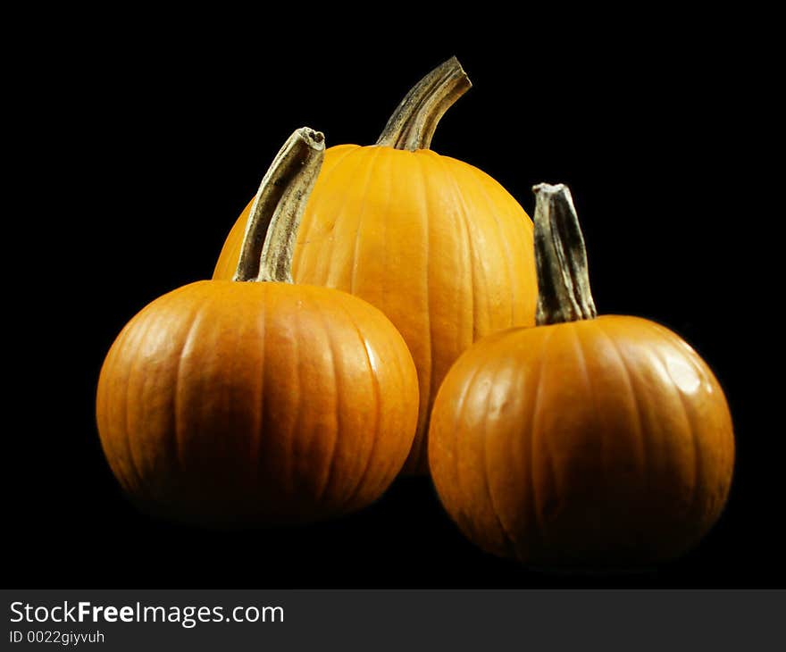 Three pumpkins isolated on black. Three pumpkins isolated on black