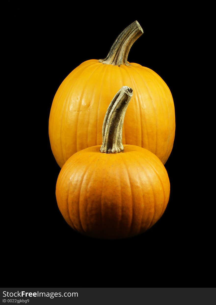 Two pumpkins isolated on black