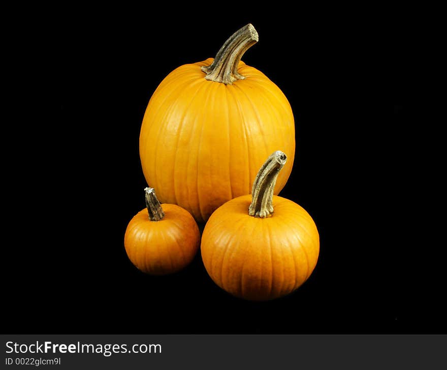 Three pumpkins isolated on black. Three pumpkins isolated on black