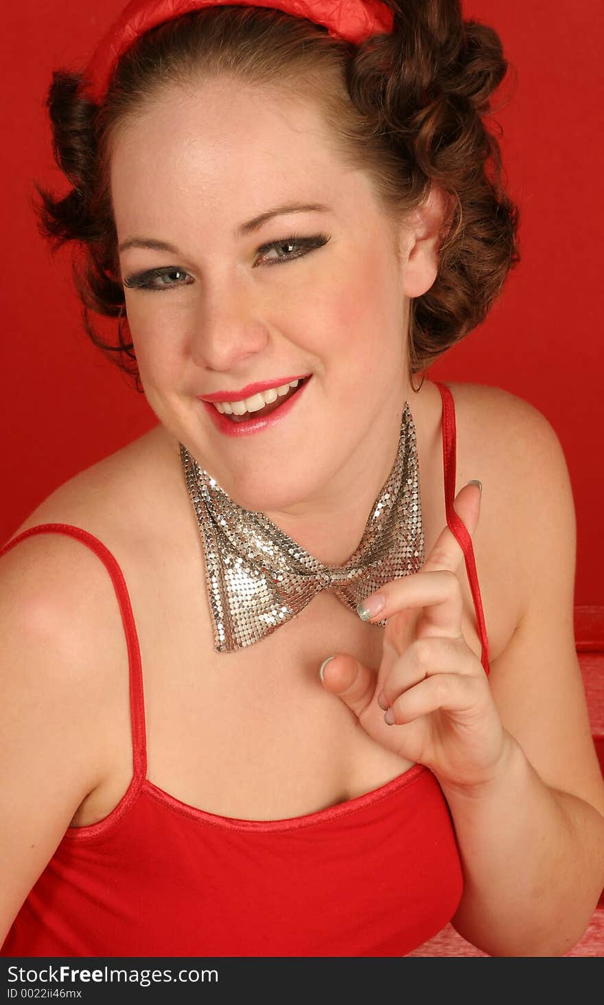 Closeup of pretty girl in red dress on red background