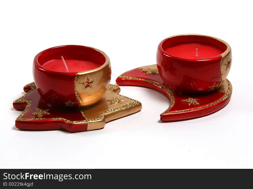 Red christmas candles on various christmas theme candleholders. Red christmas candles on various christmas theme candleholders.