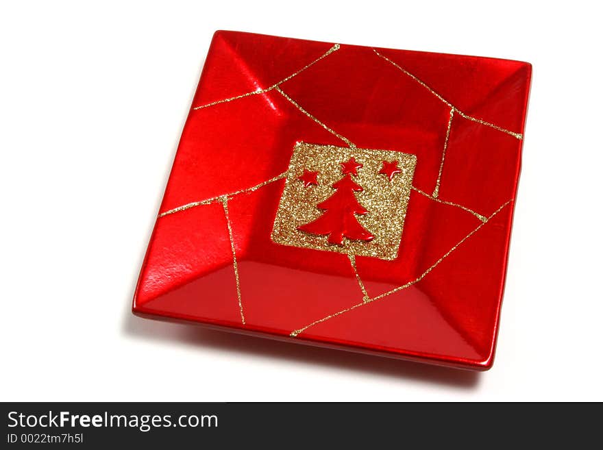 Christmas ornamental red plate with a tree isolated over a white background. Christmas ornamental red plate with a tree isolated over a white background.