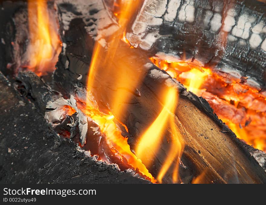 Texture of burning open fireplace with fire, flame, wood and embers