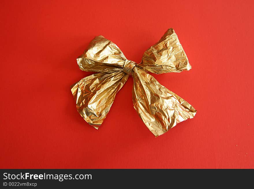 Golden ribbon on red background