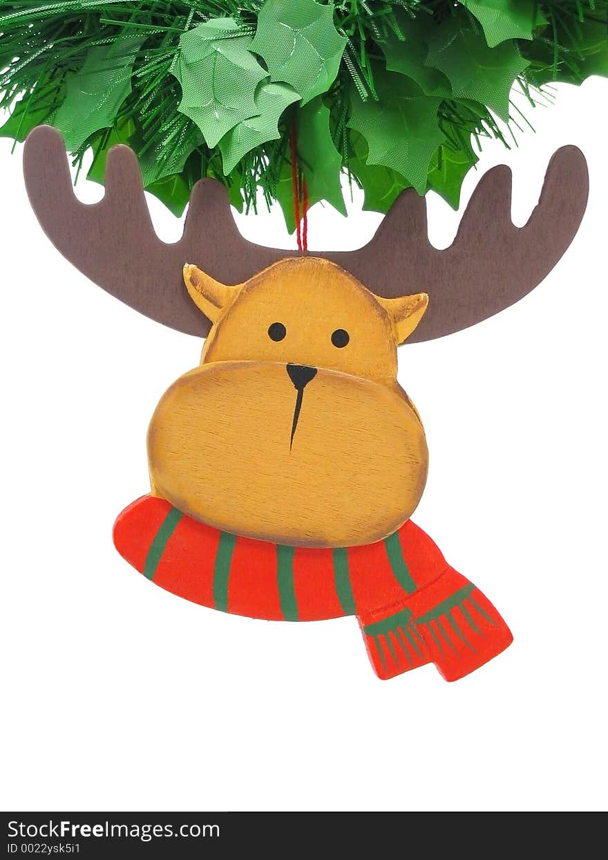 Wooden reindeer tree ornament hanging from a green garland