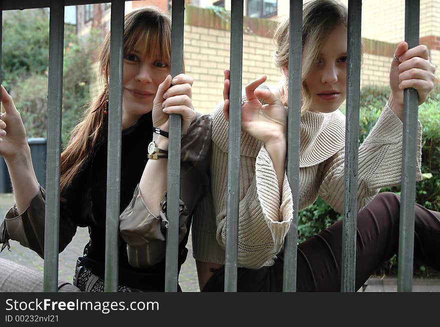 Two girls behind bars. Two girls behind bars