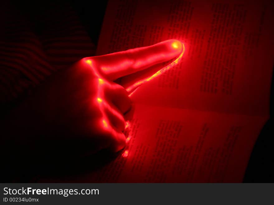 Glowing hand on a book