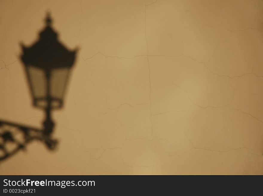 Shadow of the lamp on wall background. Use for example as a climatic, retro background