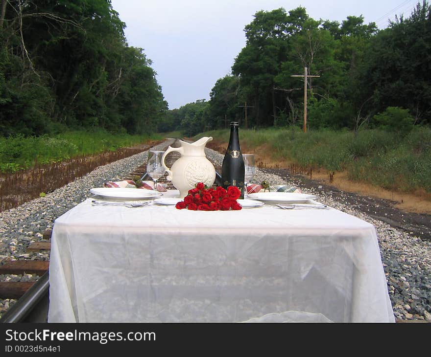 A full dinner set upon the railroad tracks. A full dinner set upon the railroad tracks.