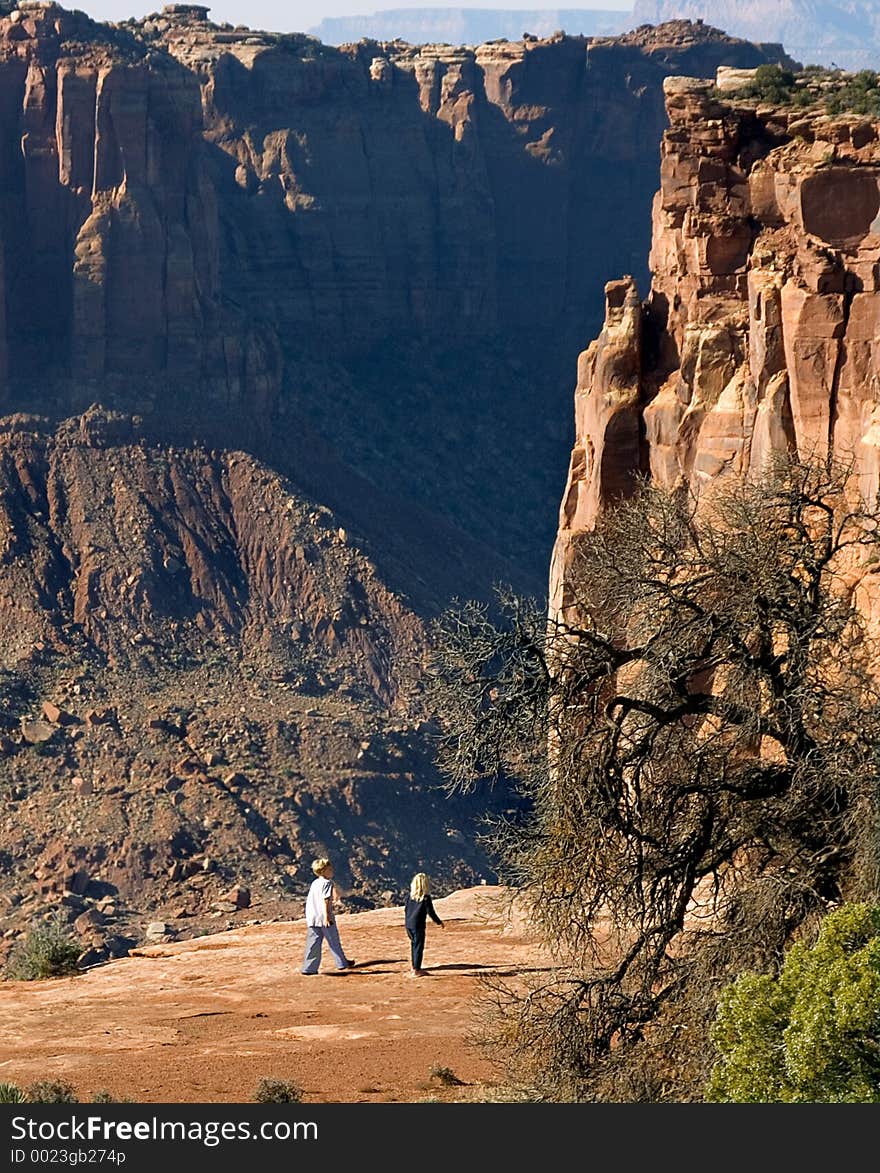 Two youngsters scamper along the high mesa in Canyonlands. Two youngsters scamper along the high mesa in Canyonlands