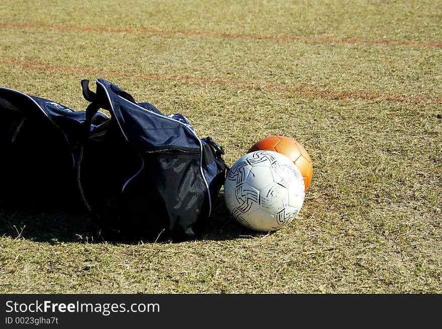 Bags and balls on the soccer field sidelines. Bags and balls on the soccer field sidelines.