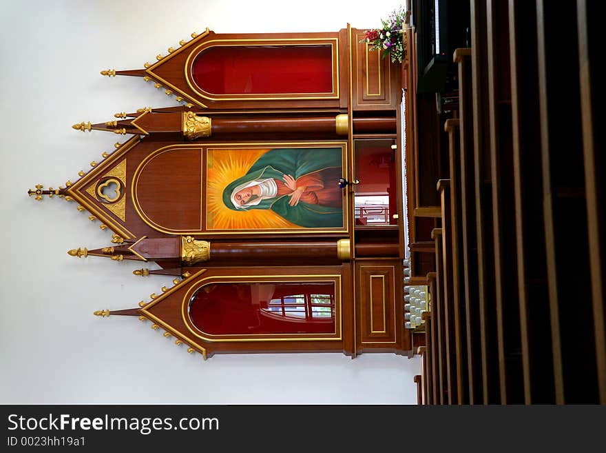 Inside of a catholic church with rows of seats in the foreground. Inside of a catholic church with rows of seats in the foreground.