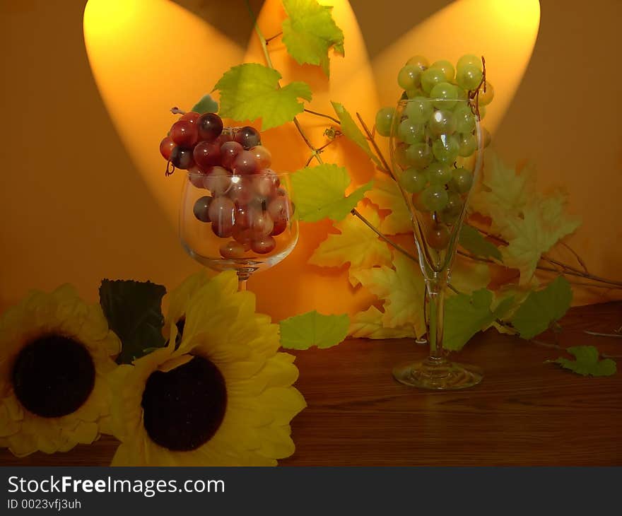 Two glasses filled with grapes with spot. Two glasses filled with grapes with spot.