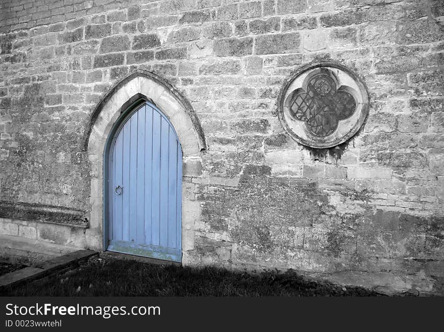 Church with the main building in monochrome and the door left in the original blue colour. Church with the main building in monochrome and the door left in the original blue colour