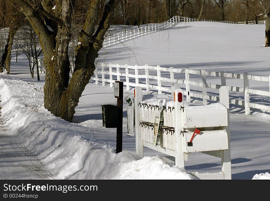 Mailboxes along side plowed rural road in winter. Mailboxes along side plowed rural road in winter