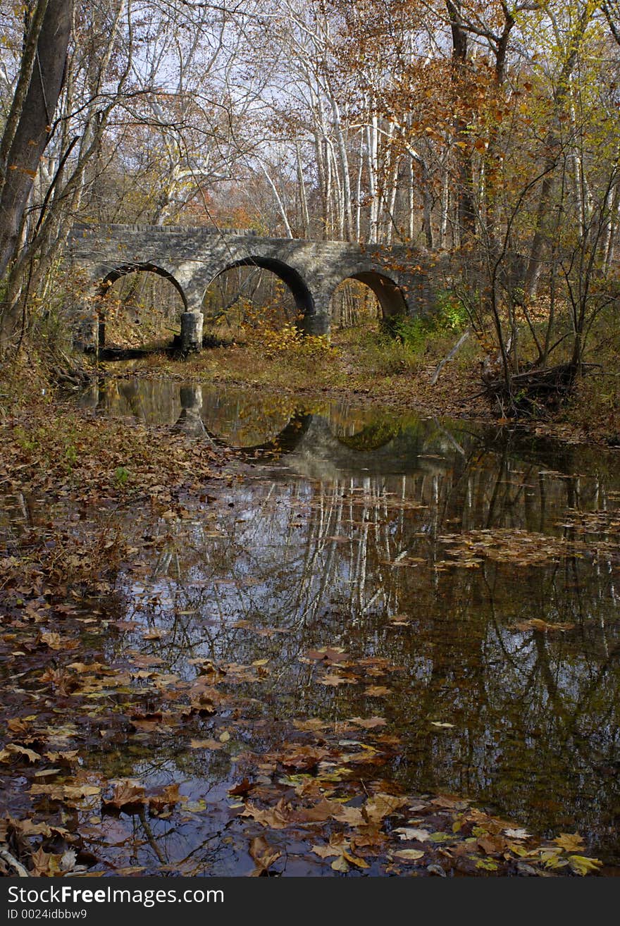 Stone bridge and creek with fall leaves. Stone bridge and creek with fall leaves