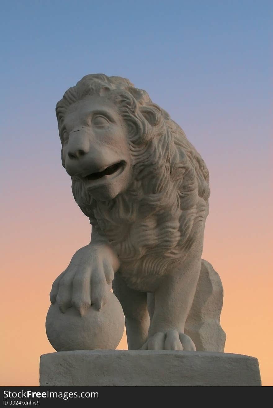 Monument to a lion on a background of a sunset. Monument to a lion on a background of a sunset