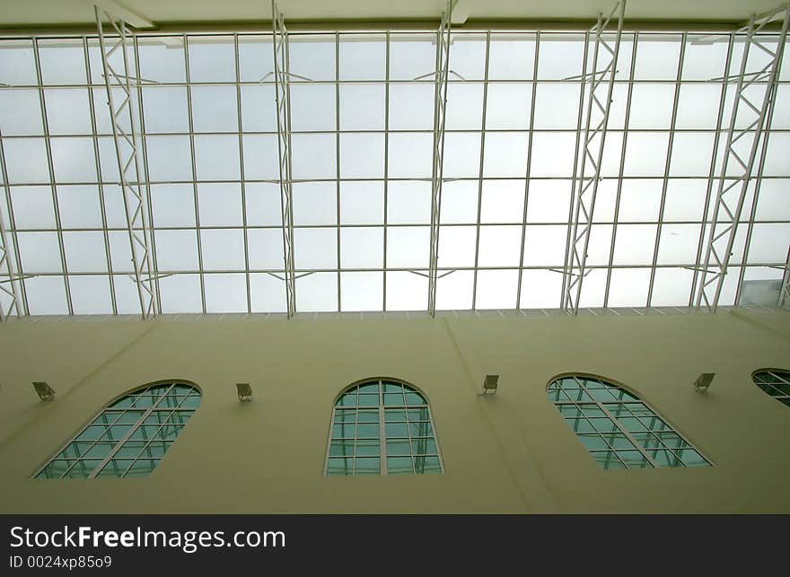 Glass ceiling in a modern open-space interior for ample natural lighting.